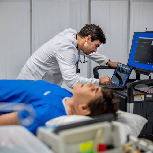 Matthew Purtee, graduate physician assistant studies student, demonstrates a high-fidelity patient simulator.